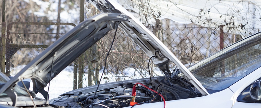 Open car bonnet with battery