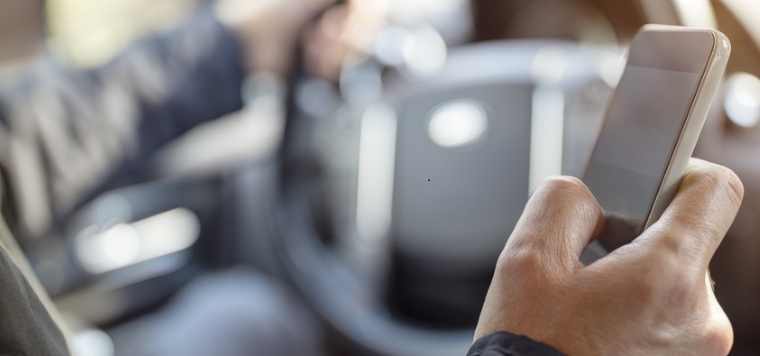 Man Using Mobile Phone In Car 