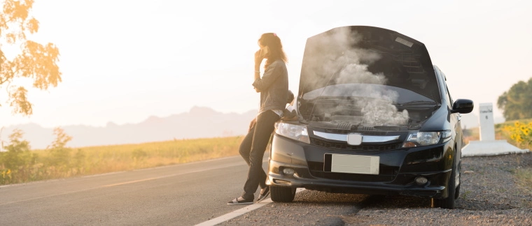 Woman stuck on a the side of a road after breaking down