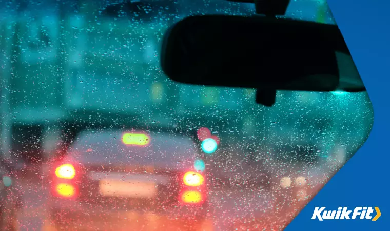  Cars in rainy traffic with sidelights lit to remain visible.