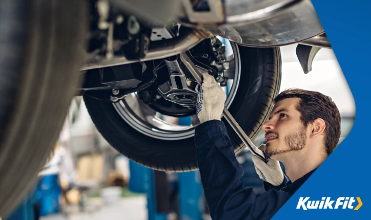 Mechanic performs routine maintenance on a vehicle.