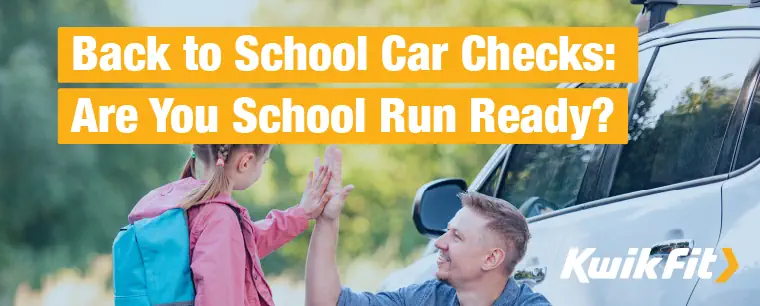 A dad and daughter high-fiving outside the car after the first school run back.