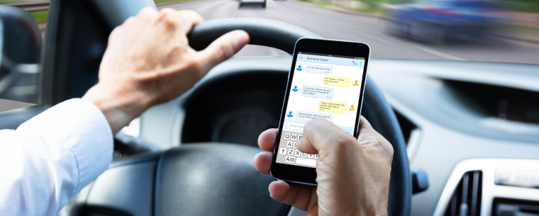 Person texting while driving a vehicle