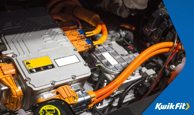 A close up of an electric vehicle motor, with large cables connected to it from the battery bank.