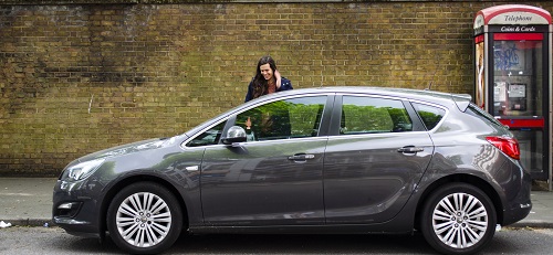 Woman outside grey car 