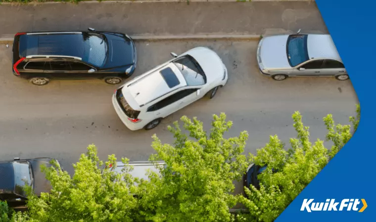 A birds-eye view of a vehicle parallel parking.