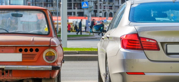 Two cars parked next to each other on the side of the road