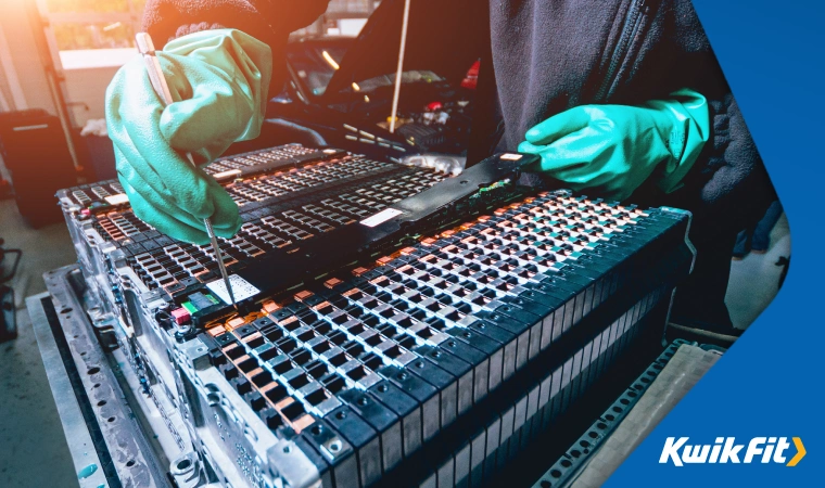 Battery technician checking individual cells for faults in a large lithium ion bank  commonly used with new EVs.