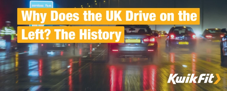 Cars on a UK motorway driving through wet weather in the night, the lights glaring in the moisture.