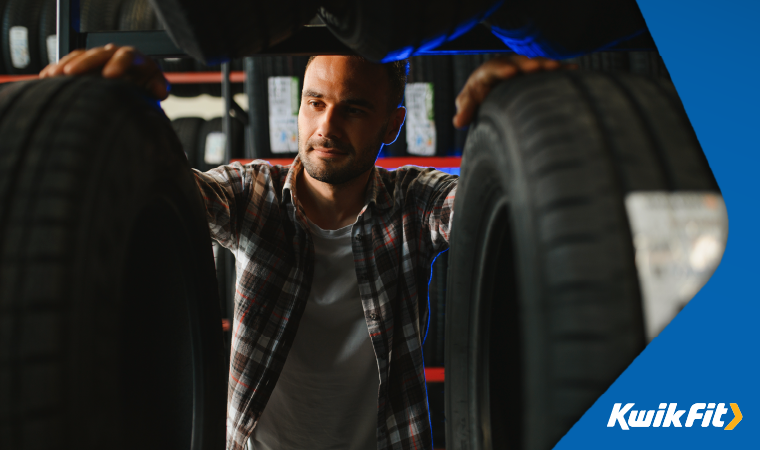 Customer looking at a rack of tyres.