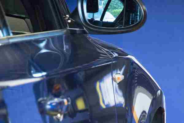 Car wing mirrors being checked during an MOT test